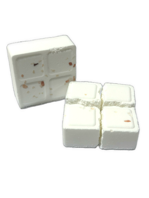 White cube-shaped shower steamer with pink Himalayan salt and small holes on the surface.