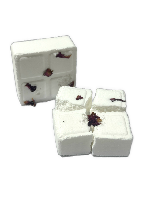 Two white cube-shaped shower steamers with dried rose petals embedded on their surfaces.