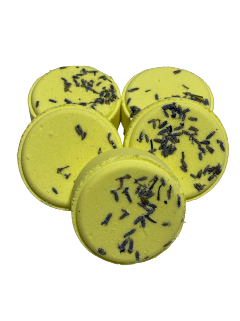 A group of yellow shower steamers with lavender buds sprinkled on top, arranged on a neutral background.