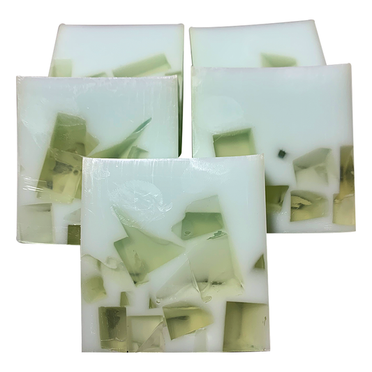 Handmade soap bars with visible green peppermint oil within the white bar, indicating a peppermint scent.