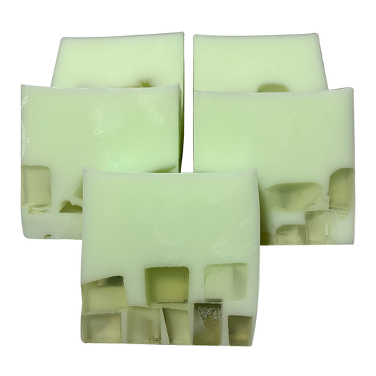 Handmade soap bars with a pale green color and what appears to be hemp seed inclusion within the bars.